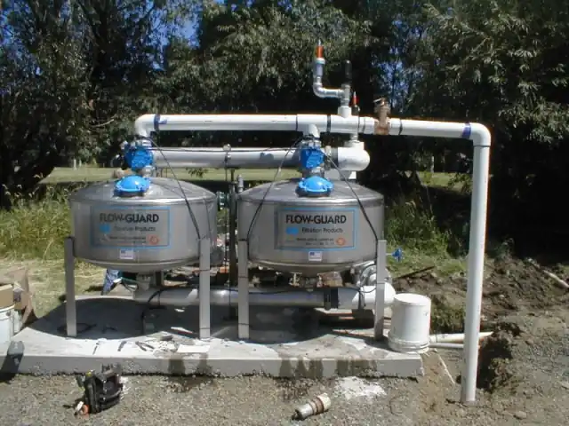 Twin Flow-Guard sand filters plumbed together on a new concrete pad
