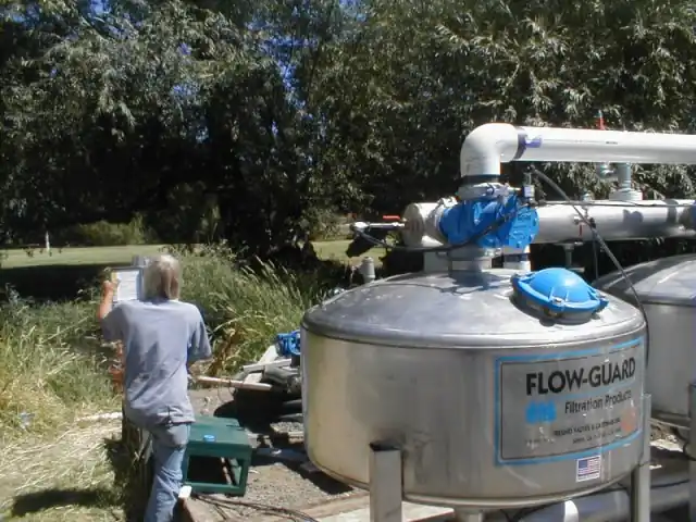 A technician standing beside a Flow-Guard filter tank