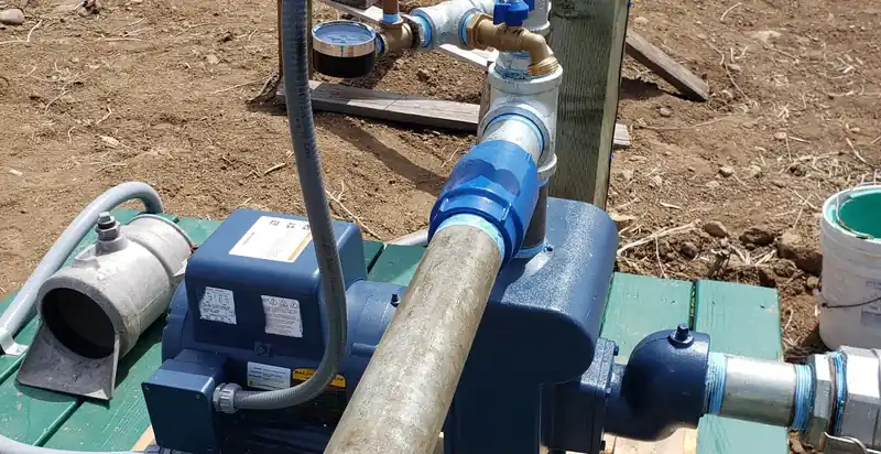 A blue jet pump mounted on a stand