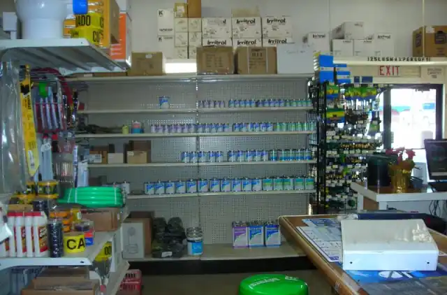A store aisle at Akland Pump with shelves of pump parts and sprinkler supplies